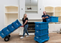 Couple smiling at each other while packing and moving items using EZPak's eco-friendly plastic bins