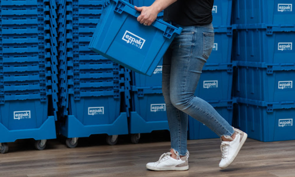 Person shown carrying an EZPak Bins whilst walking