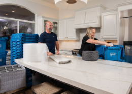 A couple packing kitchen items using EZPak's cleaner and more hygienic plastic bins